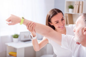 Physical therapist working with senior patient